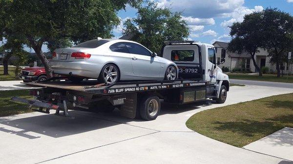 tow truck bringing car in to be fixed!