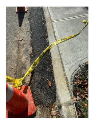 Picture of the curb with cold asphalt trying to soften the height