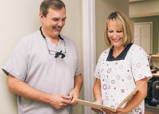 Dr. Siewert and hygienist, Courtney, look over a patient profile together.