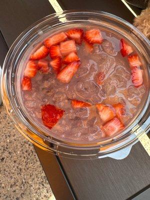 Doggie water bowl with strawberries and ice water.