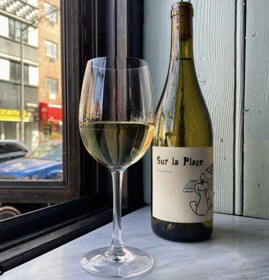 Sur la Plage. Crisp, green apple and citrus flavors with a deliciously bright minerality. Feels like summer in a glass.