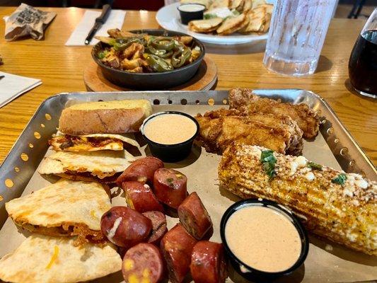 The combo smoked sausage, chicken fingers and brisket quesadillas and comes with street corn and Texas toast.