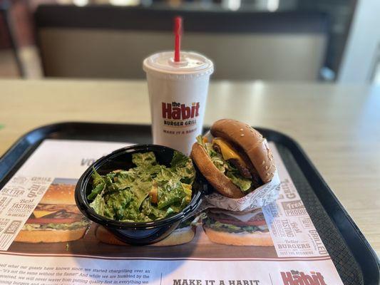 Char Burger with Cheese, side Caesar salad with a cup of water.