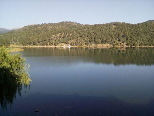 Mescelero Lake, resort fronts. After eating at the Broken Arrow taproom, check out the lake and distant views of 12,000 ft Sierra Blanca Mt.