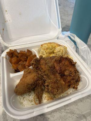 Fried chicken over rice, yams and mac and cheese