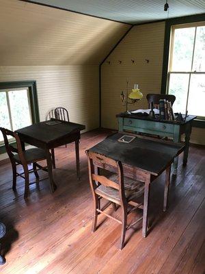 The original school desks are included in the second floor school room.