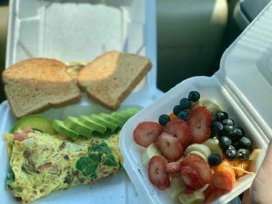 Bacon avocado omelet with a side of fruit