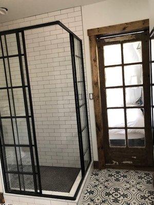 custom shower enclosure and barn doors in bathroom remodel