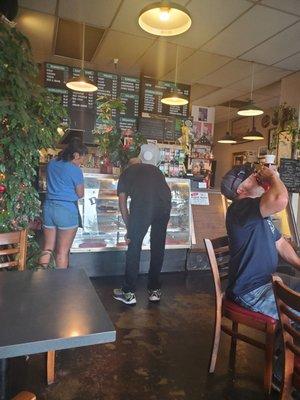 Lots of beautiful plants and the young lady on the left helping a customer.