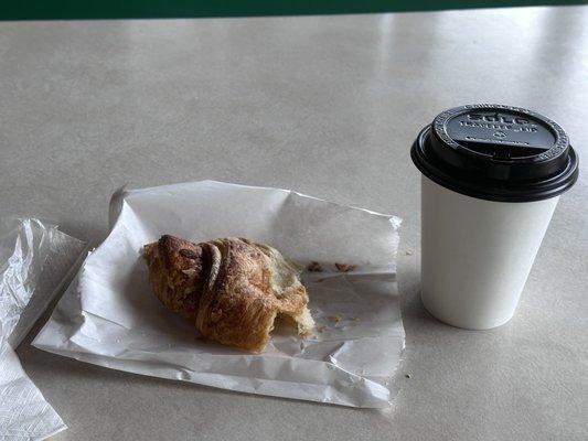 My half eaten almond croissant and coffee.