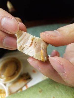 The bright lighting made it hard to see, but the chicken was pink down about half an inch into the chicken piece. Not just a surface issue.