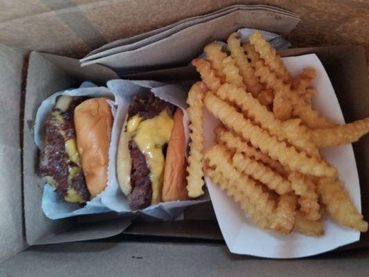 Take away: two double cheese burgers and fries. Napkins & ketchup included