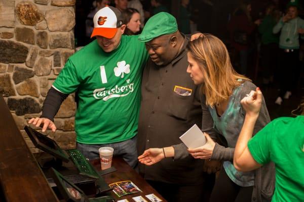 Guests at a bar on St. Patrick's Day using our kiosks to view, share, and print the photos we were taking!