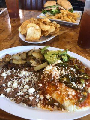 Juevos rancheros, grilled chicken sandwich and house chips.