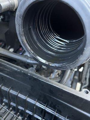 Air intake pipe filled with oil