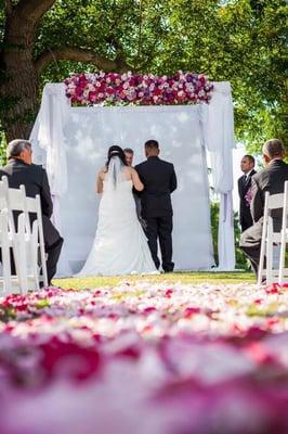 Our aisle was covered in rose petals in a beautiful design. And a floral beam for our arch