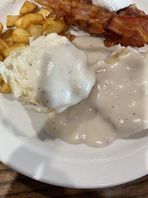 Biscuit and gravy with bacon and pan fries