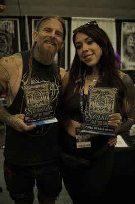 Owners Gavin & Nomi with 2 of their awards won at the 2024 Seaside Tattoo Show