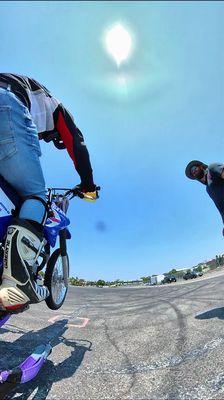 Djamil, the instructor, and I popping a wheelie