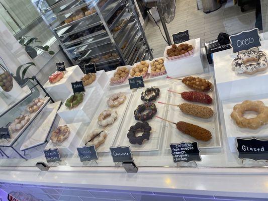 mochi donuts display; corn dog options, egg puffs, and popcorn chicken