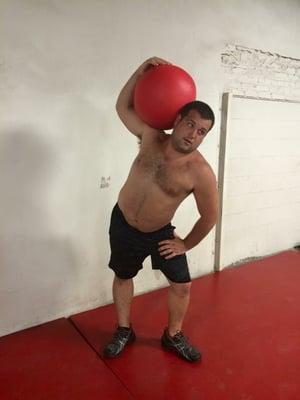 Athlete Chad S. posing after some medicine ball work.