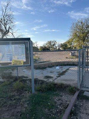 Locked gate entrances, overgrown parking lot and spaces. Posted sign is for the gate entrance only