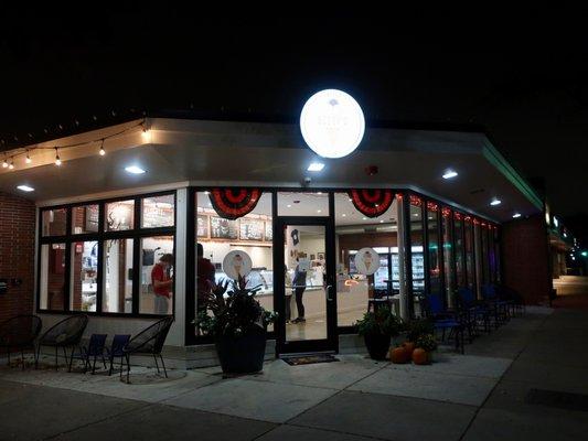 An evening view of their corner storefront.