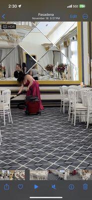 Reception guests vacuuming a dirty hall, and table setting because the venue had multiple employees quit.