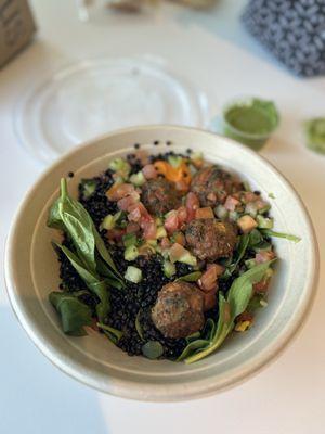 Greens and Grains bowl with falafels, black lentils, spinach, red hummus