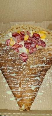 Dessert crepe with: mango, strawberries, cream cheese frosting, & drizzled with Lachera!