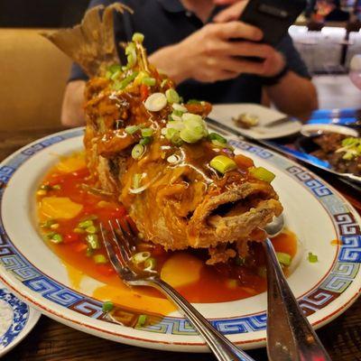 Whole fried fish in sweet and sour sauce