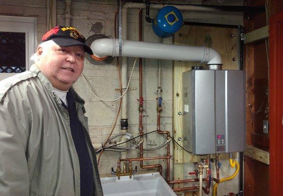 Owner John Greenway installing a Tankless water heater! Call if you wanna go Tankless!