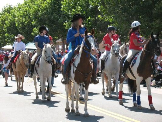 Morning Star lesson horses, students and instructors riding in the Novato 4th of July Parade.