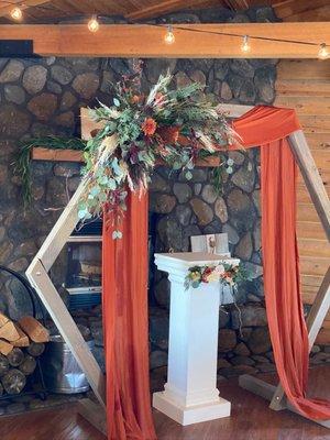 Wedding arch with live flowers (the family did the bough on the podium)