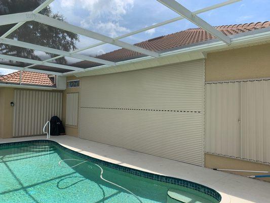 Motorized roll down and accordion shutters.