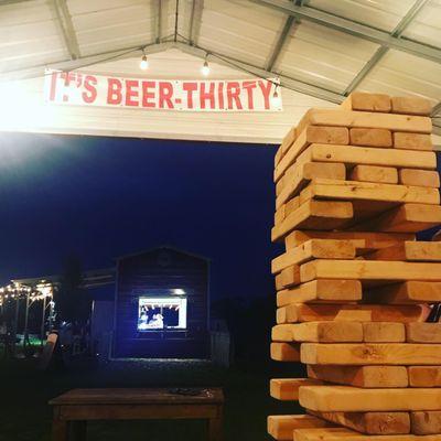 Giant Jenga with beverage barn in the background.