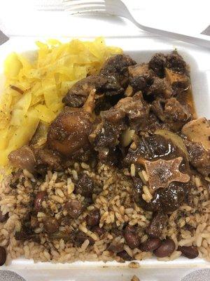 Oxtail, cabbage, rice and peas good flavor a lot of food to be a small