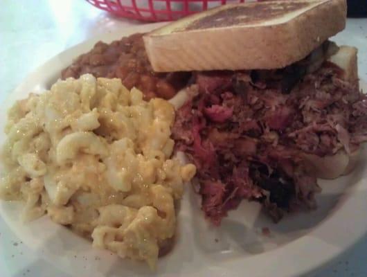 Burnt end sandwich with homemade beans and Mac/cheese.