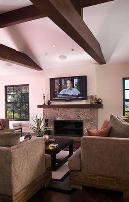 A mounted Plasma TV with flush mount in wall speakers, creating a gorgeous picture with clean, full sound.