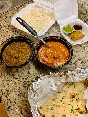 Lamb Saag (left), Paneer Tikki Masala (right), Garlic naan (bottom), and vegetable samosa (top)