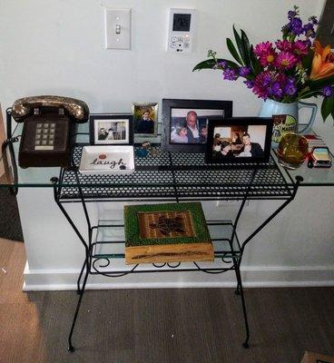 Love my wrought iron console table. Modernized the look with thick glass shelves