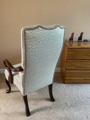 Beautifully done nailhead trim on the contrasting fabric on the back of the chairs.