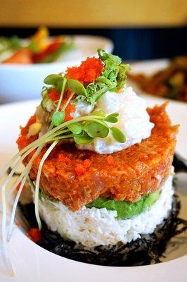 Creamy Scallop Tower: creamy scallop, crab, spicy tuna, avocado, masago, green onion layer-stacked with sushi rice. Lite spicy ($13).