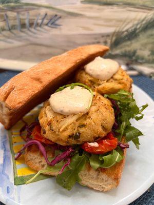 Crab cake Sandwich. Maryland style  cakes, jalapeño/lime slaw, marinated cherry tomatoes, coriander aioli, arugula on toasted Francese roll