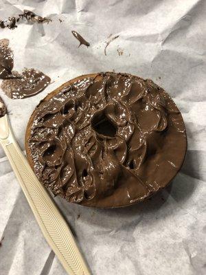 Plain bagel with globs of Nutella.