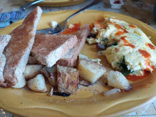 Spinach, Feta and Olive omelette with hot sauce, home fries and toast.