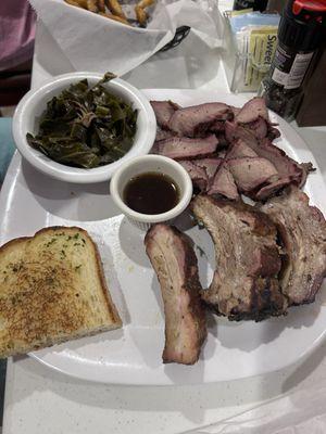 Ribs, brisket, greens, fries, and garlic bread.