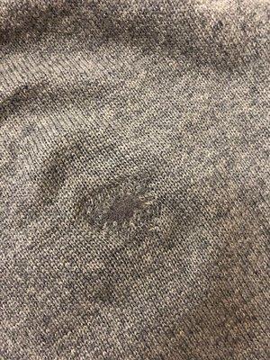 Repaired hole on sweater.