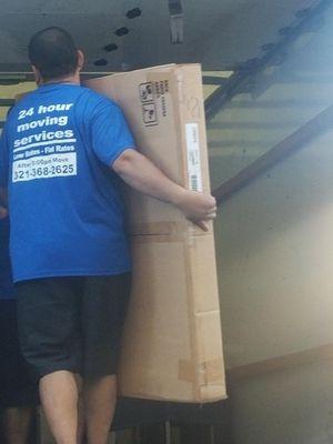 Movers lifting heavy object