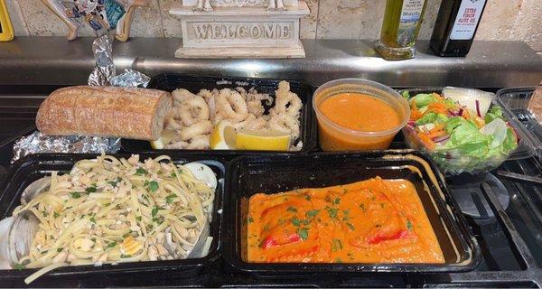 Lobster ravioli, linguini and clams in white sauce, fried calamari, shrimp bisque soup and side salad